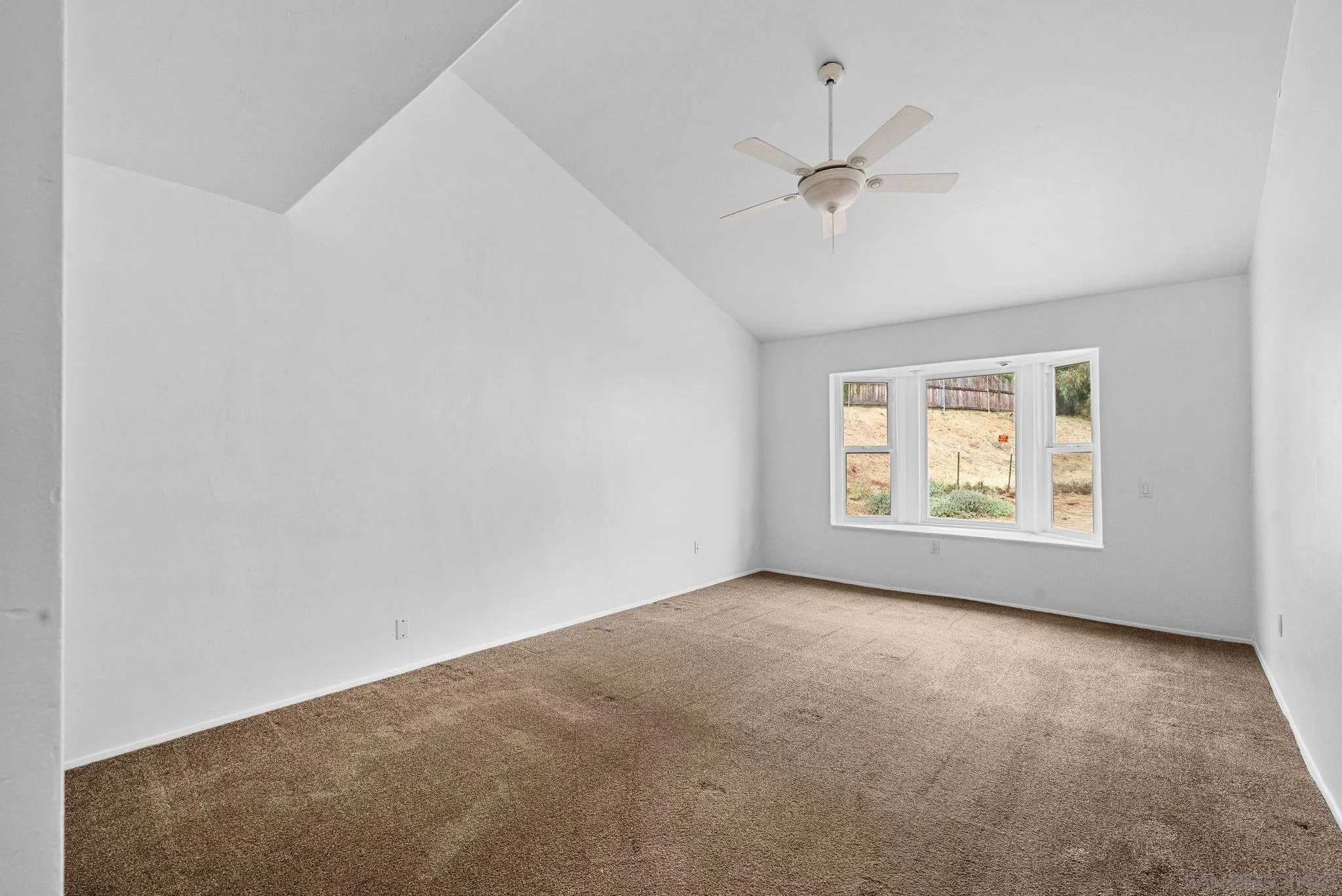 11507 Pinehurst Drive Lakeside, CA 92040 - Photo 18 of 25 an empty room with a ceiling fan and window