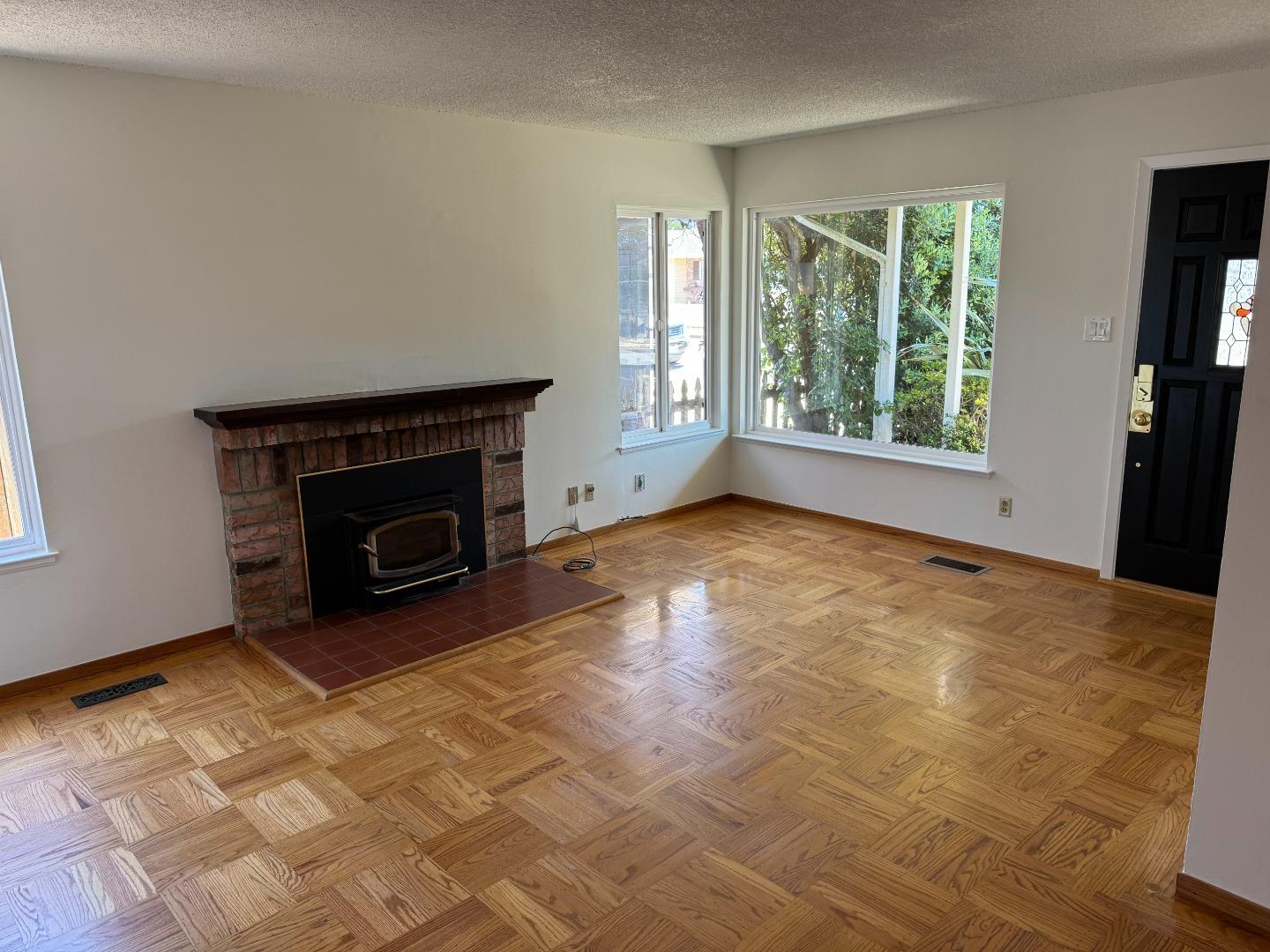 155 Shell Street Pacifica, CA 94044 - Photo 4 of 10 an empty room with windows and fireplace
