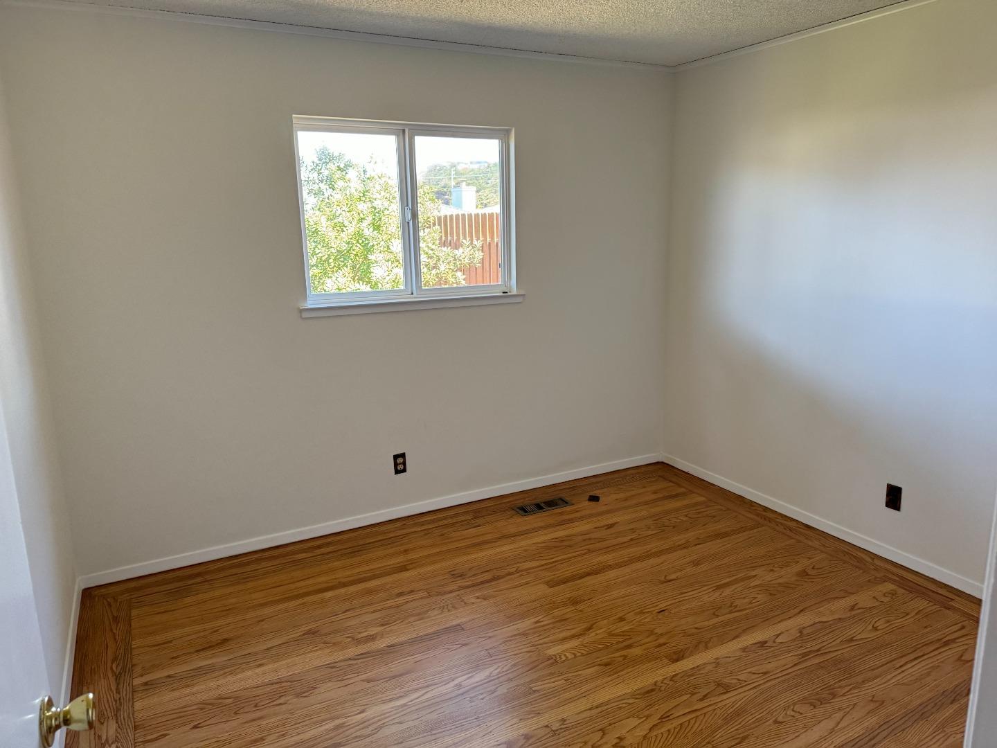 155 Shell Street Pacifica, CA 94044 - Photo 8 of 10 a view of empty room with wooden floor