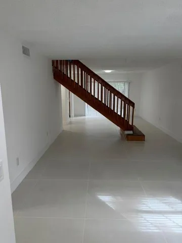 a view of staircase with white walls