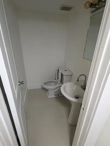 a bathroom with a toilet and sink