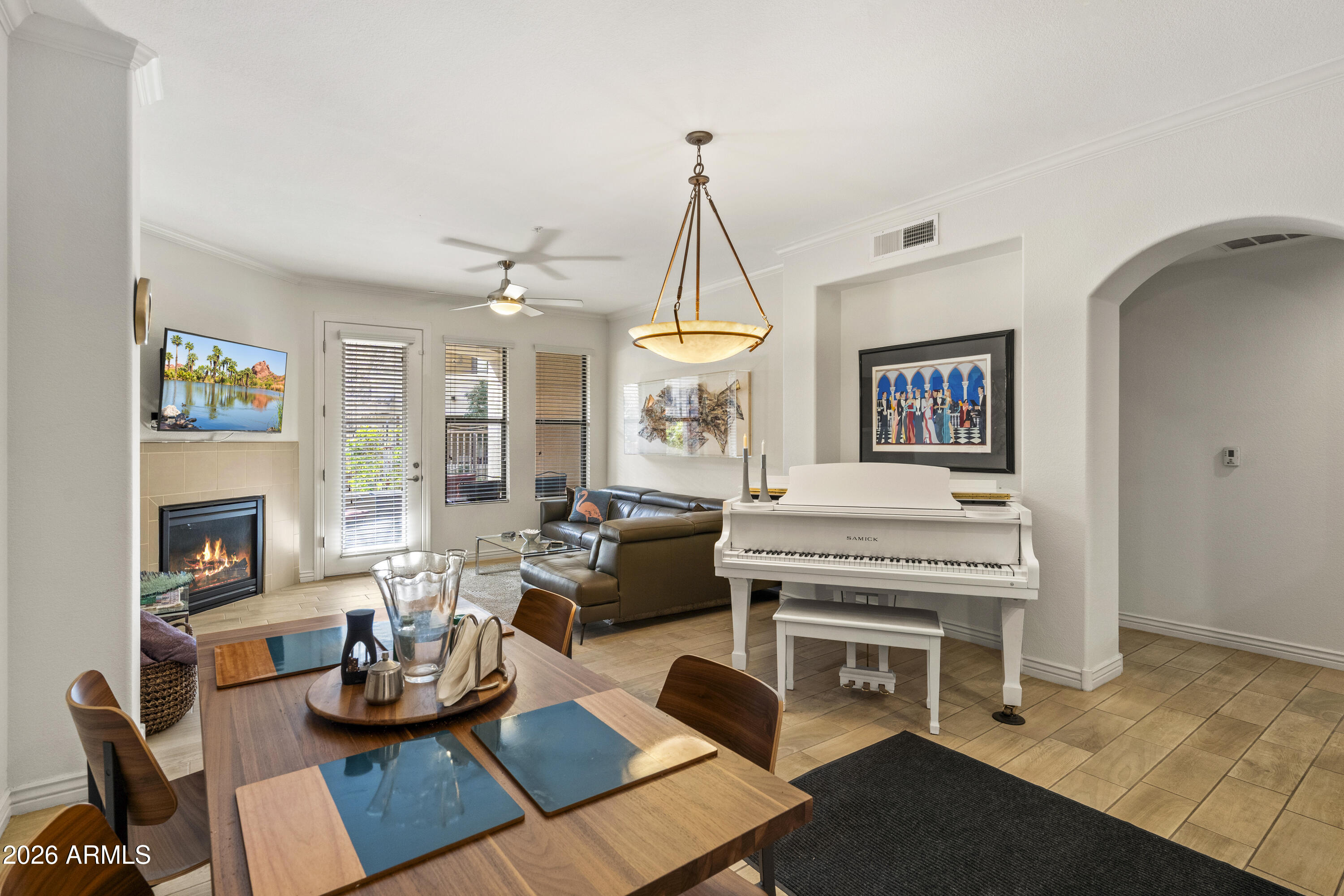 a living room with furniture a fireplace and a flat screen tv