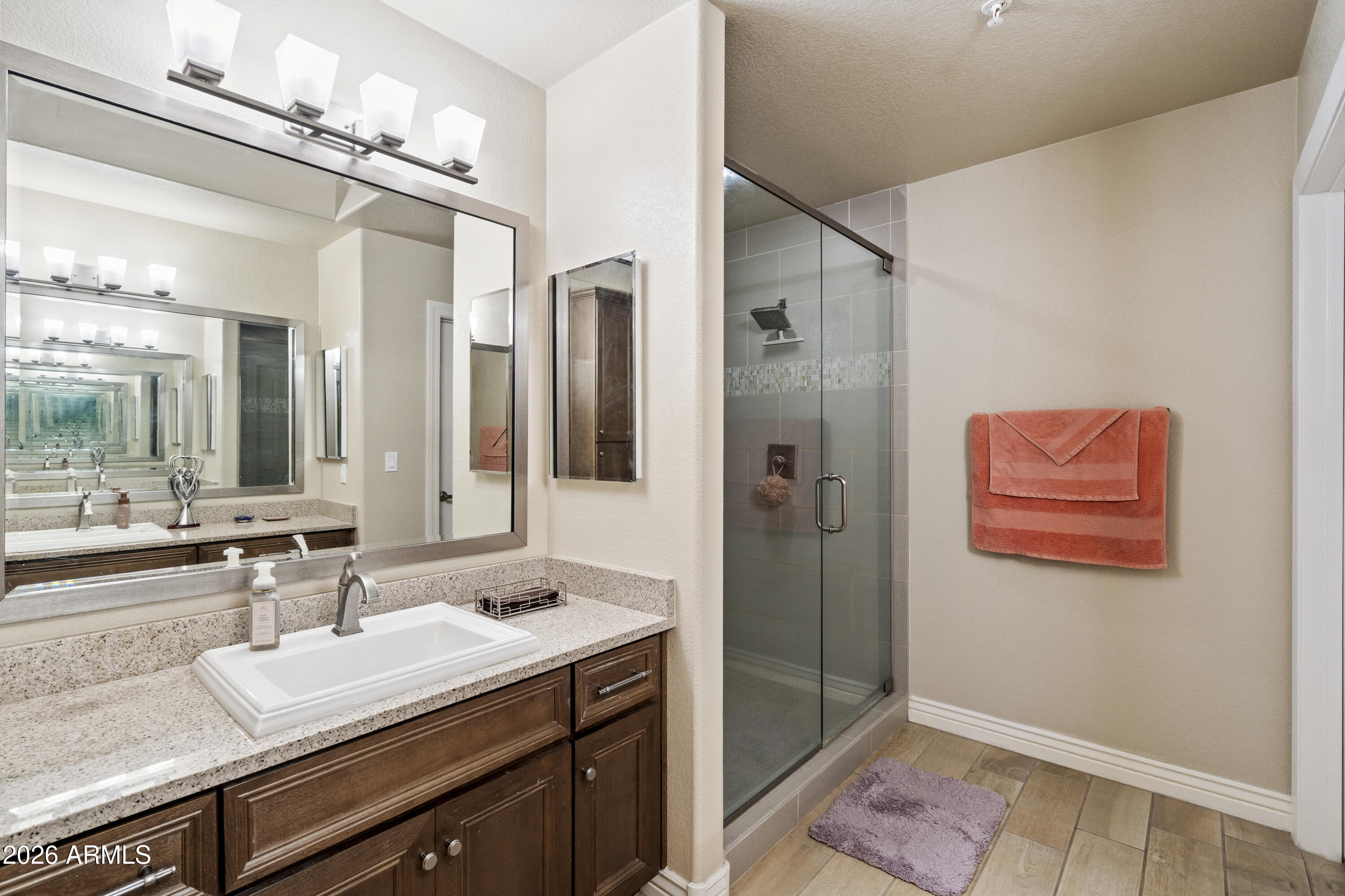 7601 East Indian Bend Road, Unit 1012 Scottsdale, AZ 85250 - Photo 18 of 27 a spacious bathroom with a granite countertop sink and a mirror