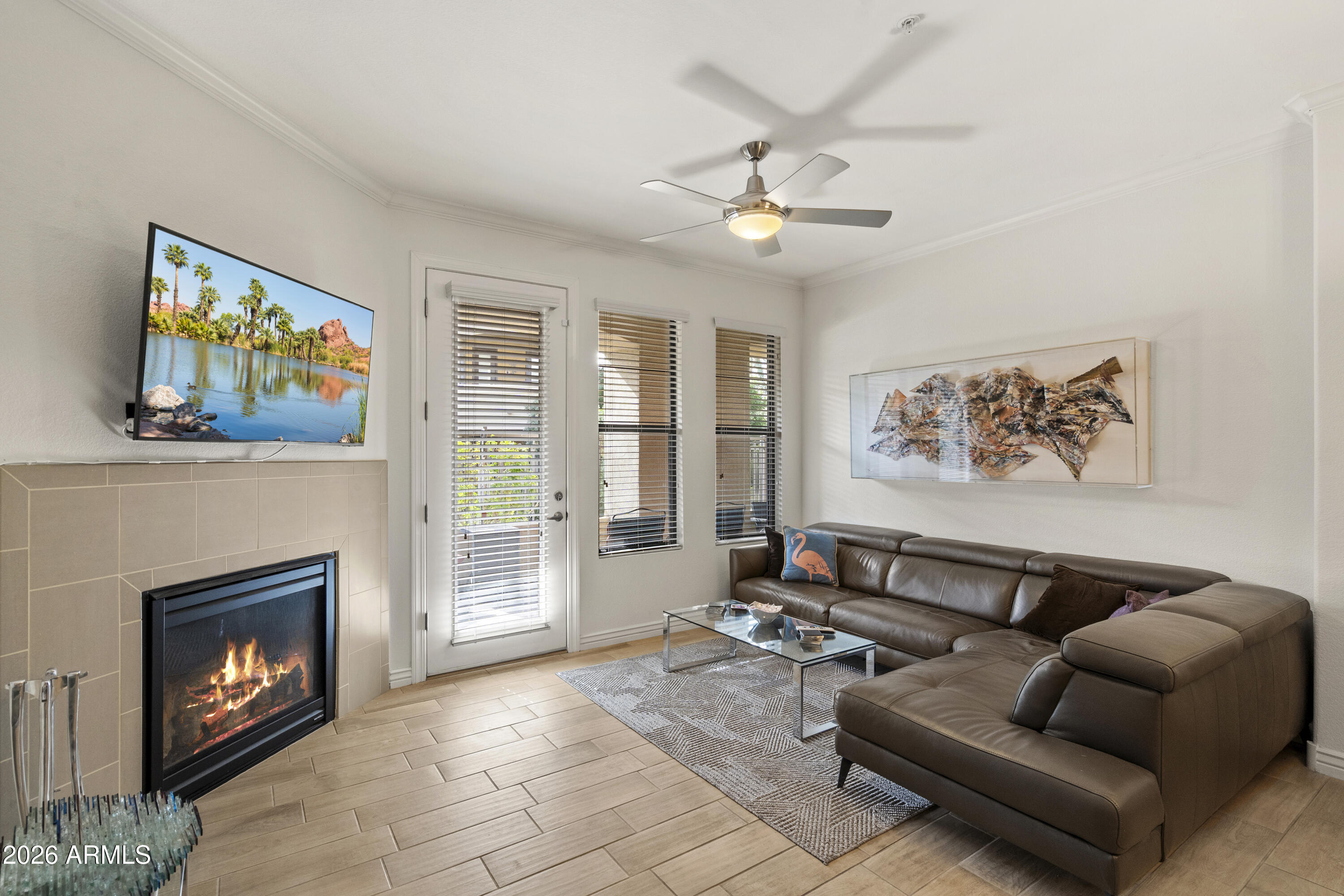 7601 East Indian Bend Road, Unit 1012 Scottsdale, AZ 85250 - Photo 2 of 27 a living room with furniture and a fireplace