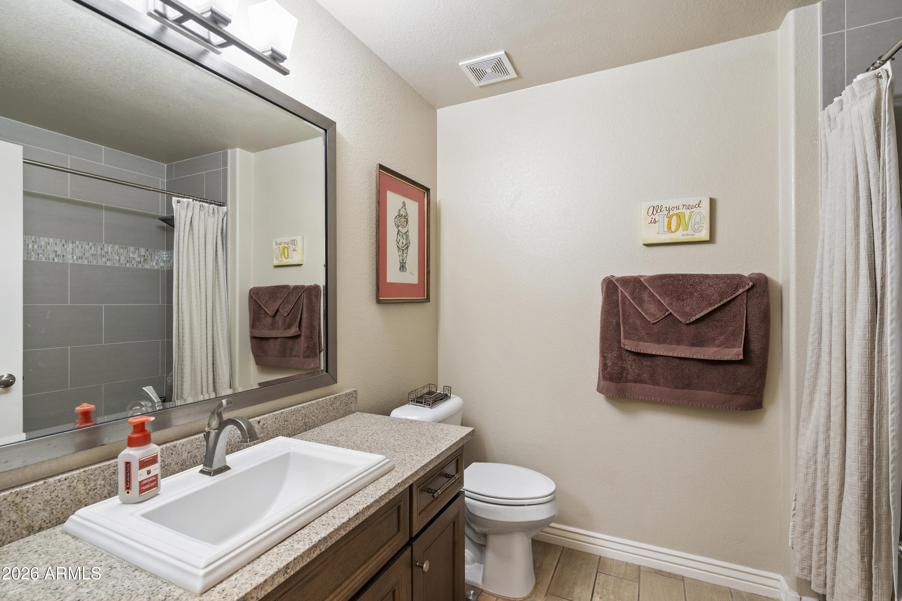 7601 East Indian Bend Road, Unit 1012 Scottsdale, AZ 85250 - Photo 22 of 27 a bathroom with a sink a toilet and mirror