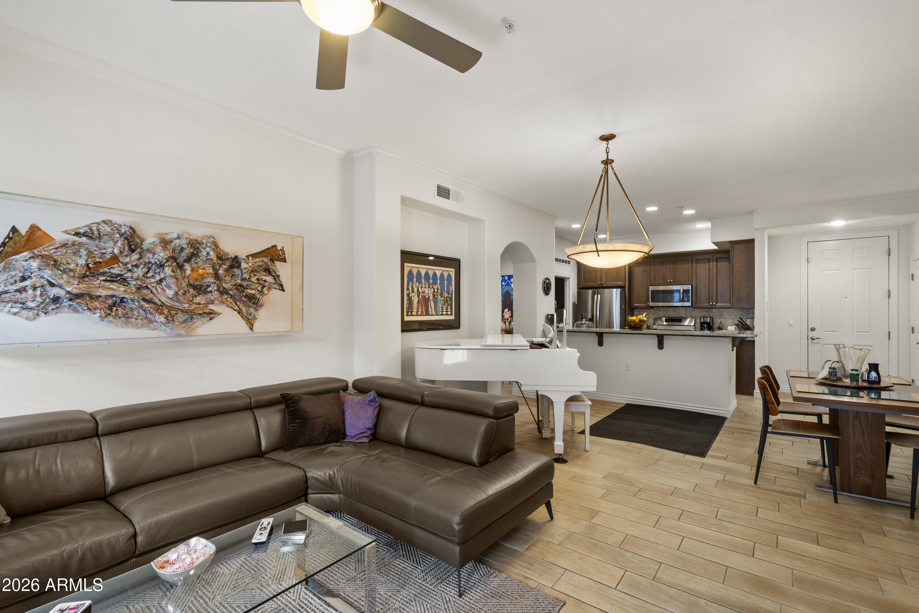 7601 East Indian Bend Road, Unit 1012 Scottsdale, AZ 85250 - Photo 3 of 27 a living room with furniture and kitchen view