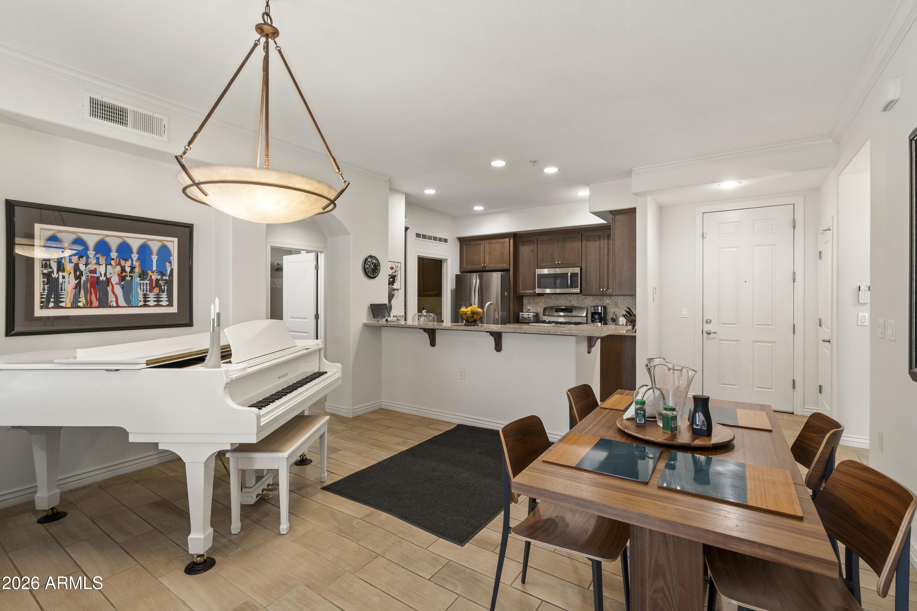 7601 East Indian Bend Road, Unit 1012 Scottsdale, AZ 85250 - Photo 8 of 27 a living room with furniture a dining table and a chandelier