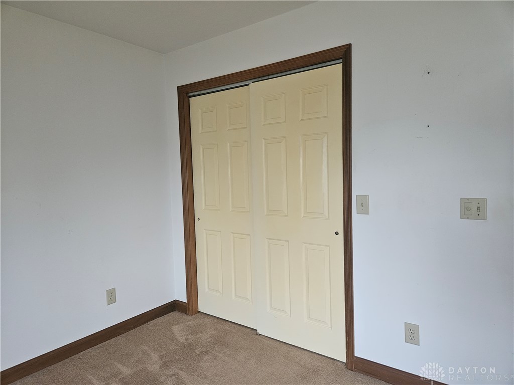 4909 Shannon Avenue Springfield, OH 45504 - Photo 11 of 21 This cozy bedroom features warm carpeting and a spacious closet, perfect for comfortable living.