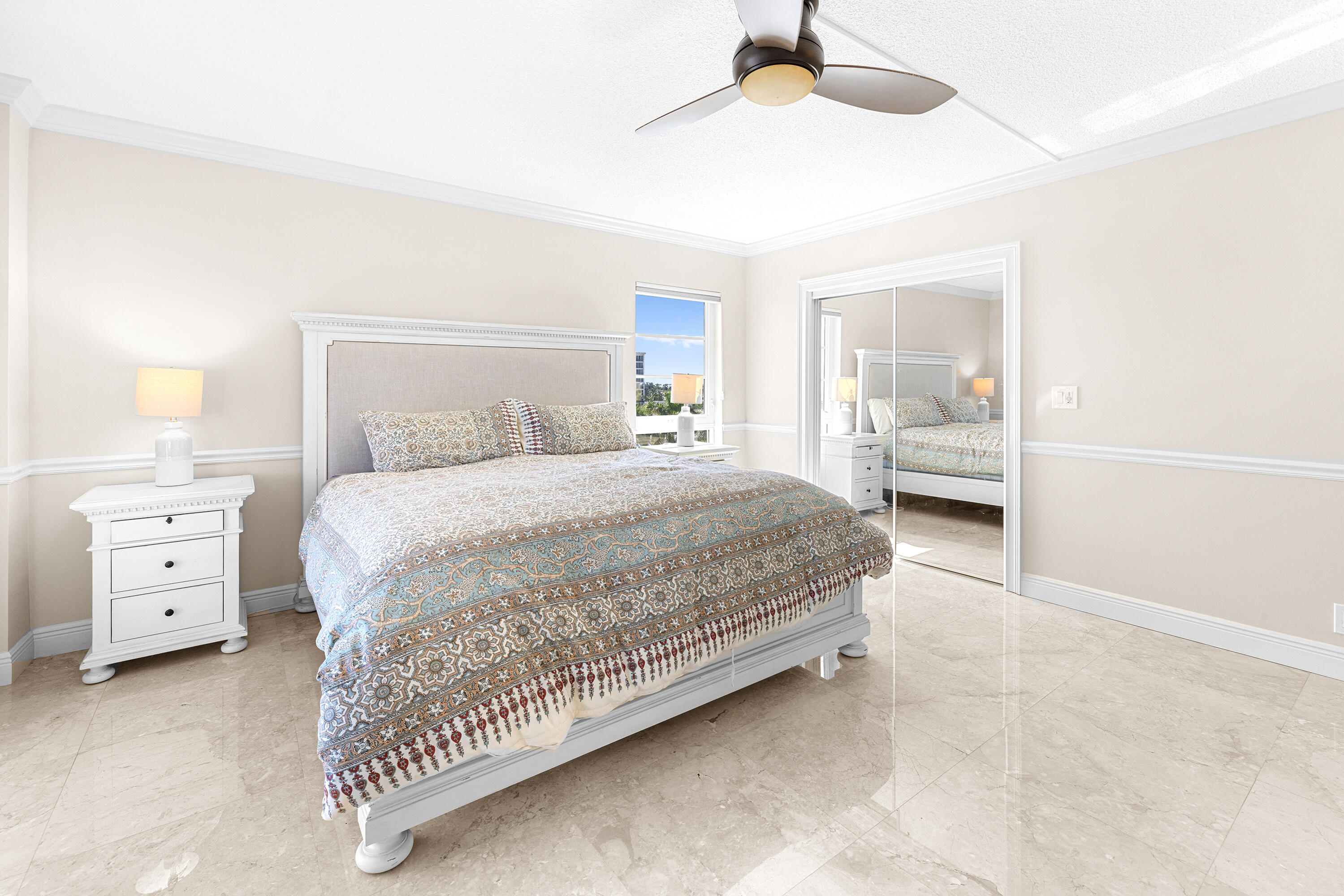 50 E Road, Unit 6E Delray Beach, FL 33483 - Photo 16 of 36 a bedroom with a bed and a chandelier