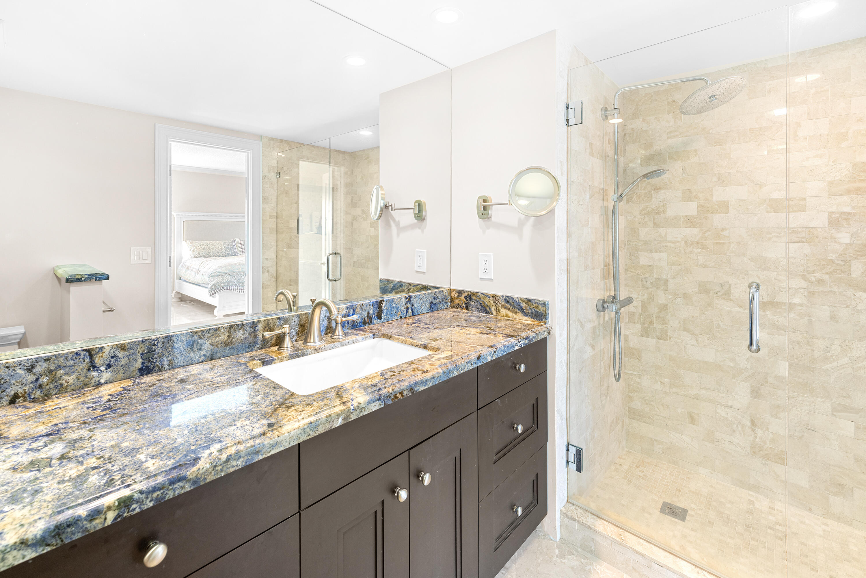 50 E Road, Unit 6E Delray Beach, FL 33483 - Photo 19 of 36 a bathroom with a granite countertop sink a mirror and a shower