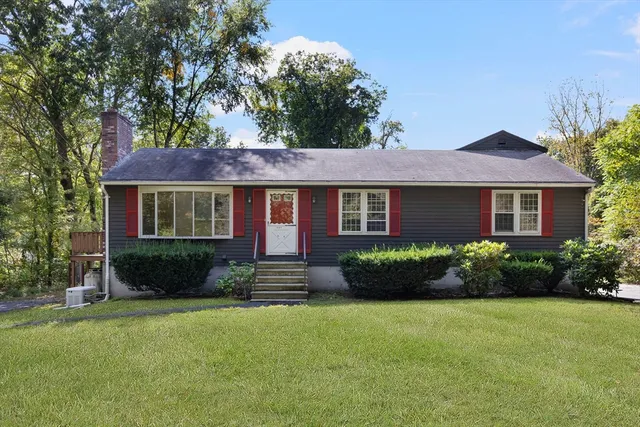 a front view of a house with a yard