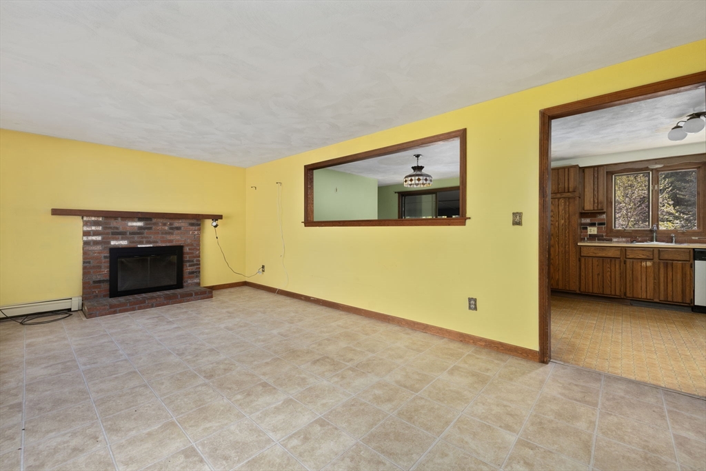 40 Union Street Blackstone, MA 01504 - Photo 13 of 40 a view of an empty room with a fireplace and a window