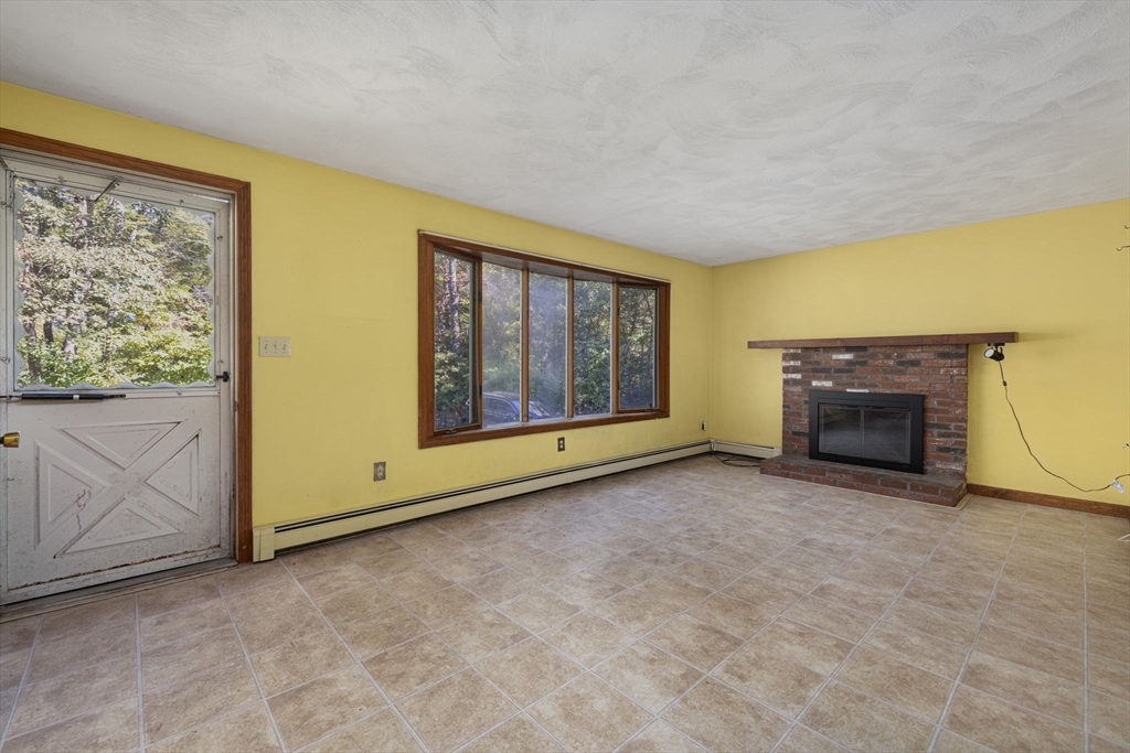40 Union Street Blackstone, MA 01504 - Photo 14 of 40 a view of an empty room with a fireplace and a window