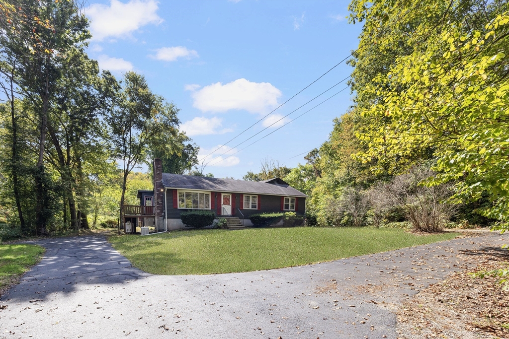 40 Union Street Blackstone, MA 01504 - Photo 2 of 40 a front view of a house with a yard and trees