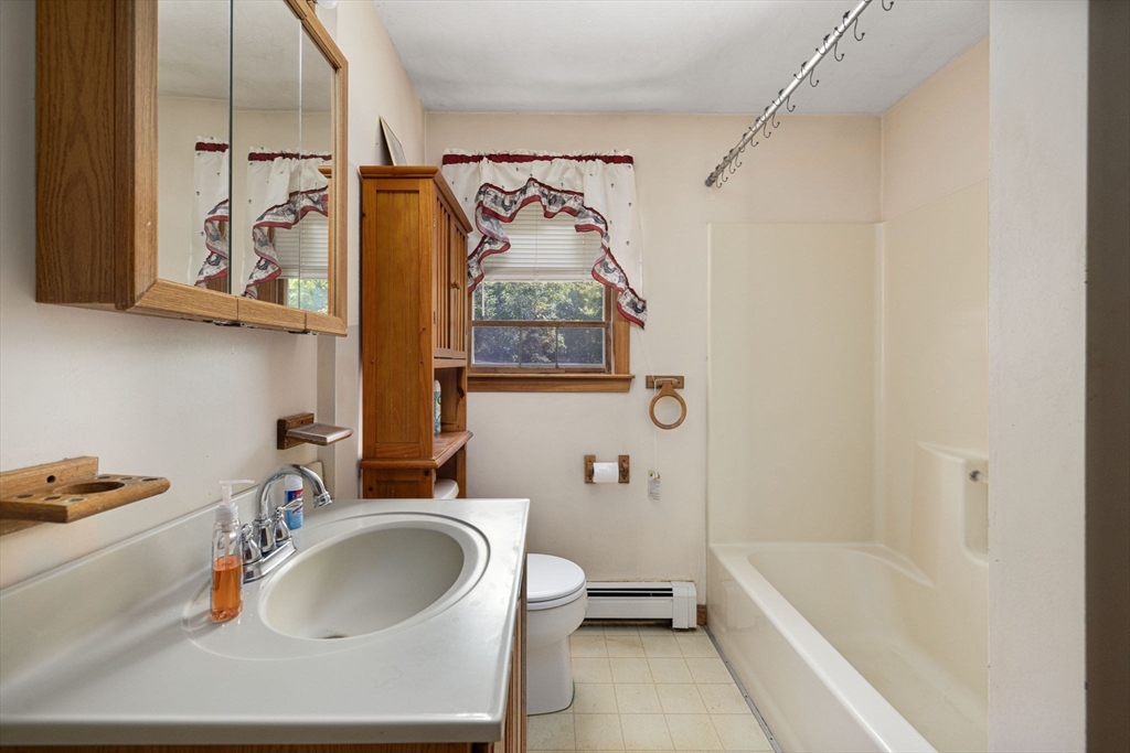 40 Union Street Blackstone, MA 01504 - Photo 30 of 40 a bathroom with a sink a mirror and a bathtub