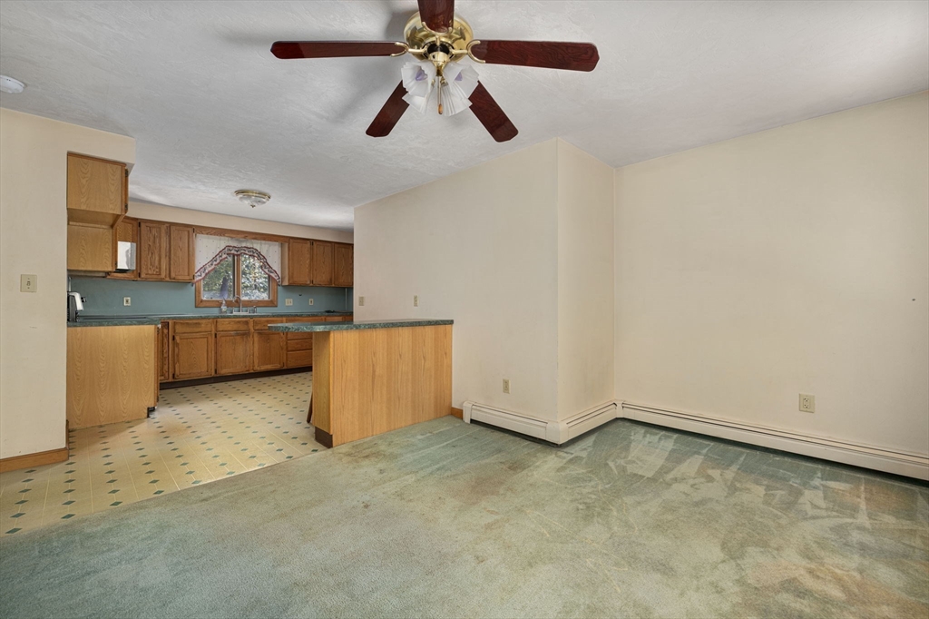 40 Union Street Blackstone, MA 01504 - Photo 31 of 40 an empty room with chandelier fan and windows