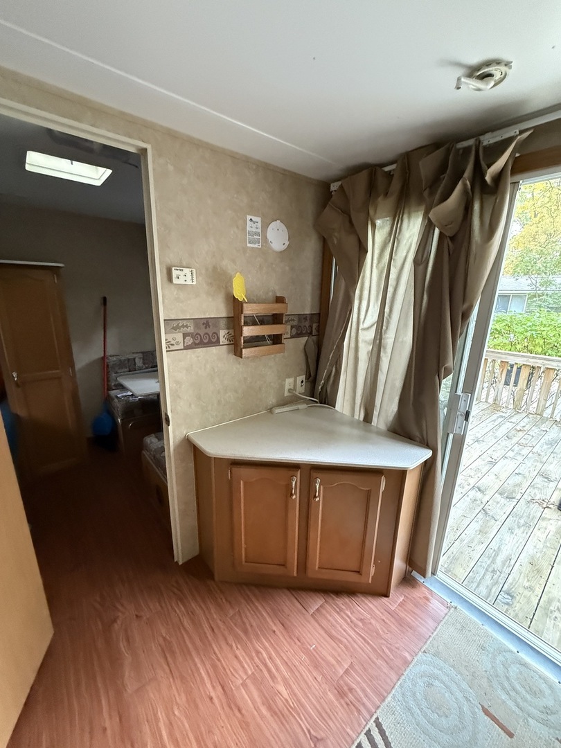 1-108 Woodhaven Lakes Sublette, IL 61367 - Photo 15 of 17 a view of kitchen with furniture and wooden floor