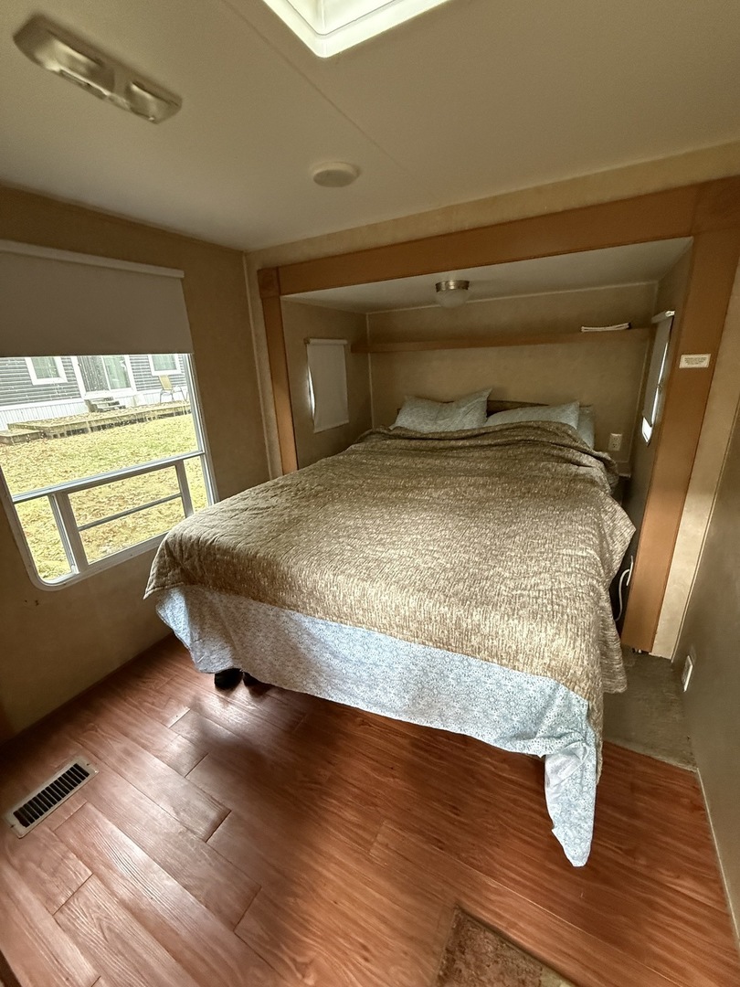 1-108 Woodhaven Lakes Sublette, IL 61367 - Photo 10 of 17 a bedroom with a bed and wooden floor