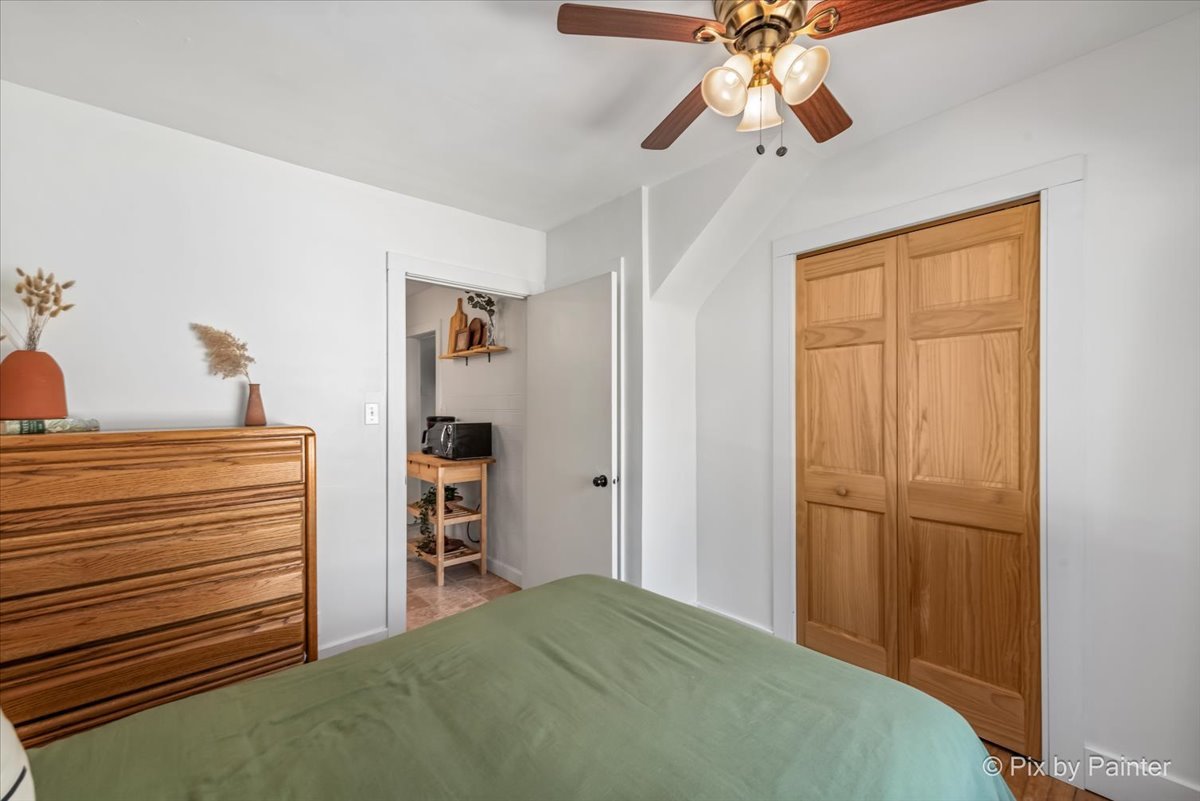 302 Circle Road Fox River Grove, IL 60021 - Photo 14 of 35 a bedroom with a bed and a chandelier
