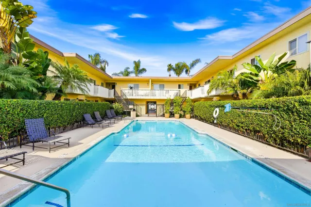 a view of swimming pool with outdoor seating and plants