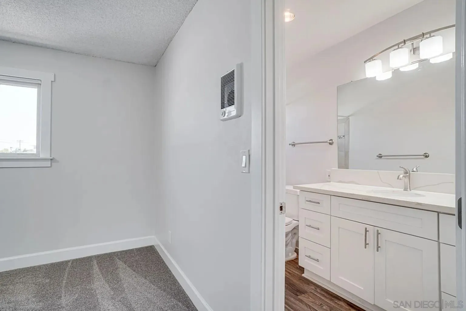 600 F Street Chula Vista, CA 91910 - Photo 10 of 12 a bathroom with a sink a toilet and a mirror