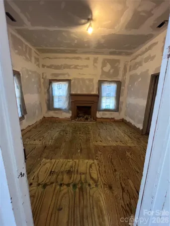 a view of empty room with window and fireplace