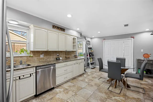 a kitchen with table chairs cabinets and stainless steel appliances