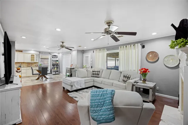 a living room with furniture and a wooden floor