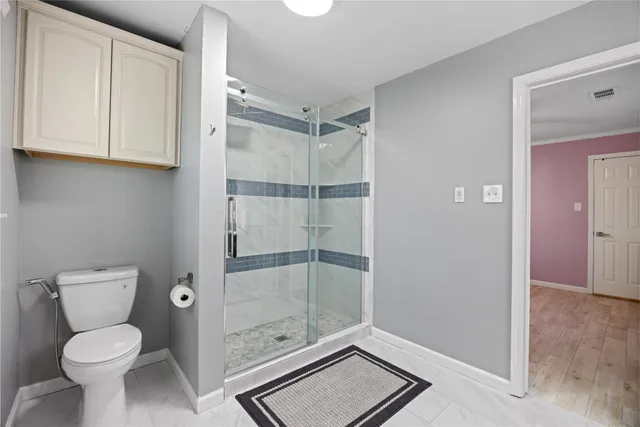 a bathroom with a toilet and a shower