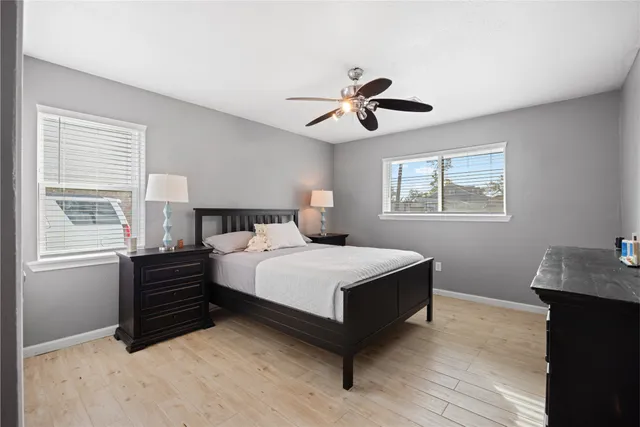 a bedroom with a bed dresser and a window