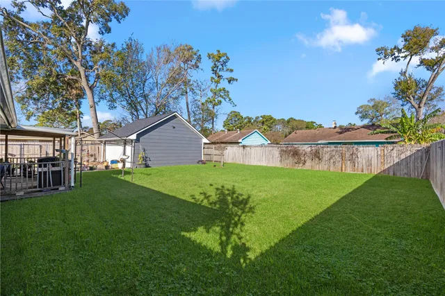 a view of a house with a yard and a garden