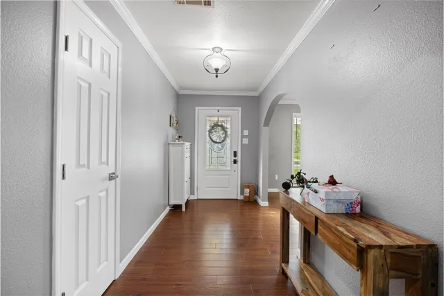 a view of an entryway with wooden floor