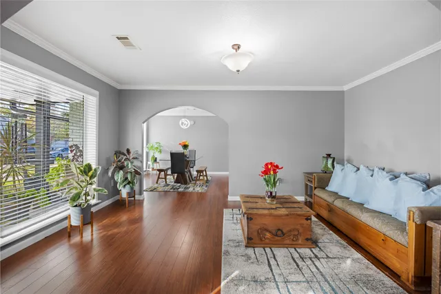 a living room with furniture and wooden floor