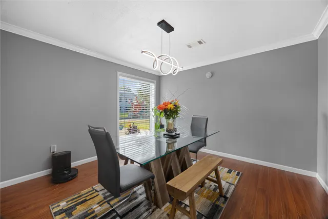 a view of a dining room with furniture window and wooden floor