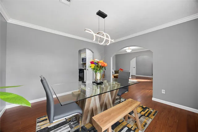 a view of a dining room with furniture and wooden floor