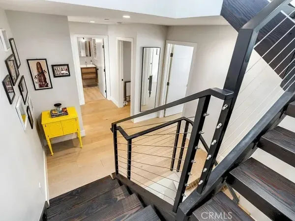 a view of a livingroom with furniture and stairs