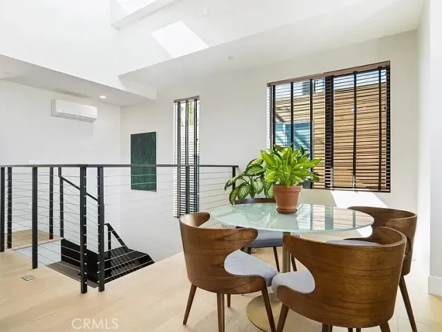 a dining room with furniture and floor to ceiling windows