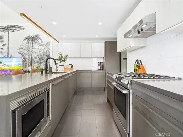 a kitchen with stainless steel appliances granite countertop a stove and a sink