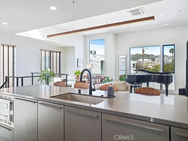 a kitchen with a sink and a large window