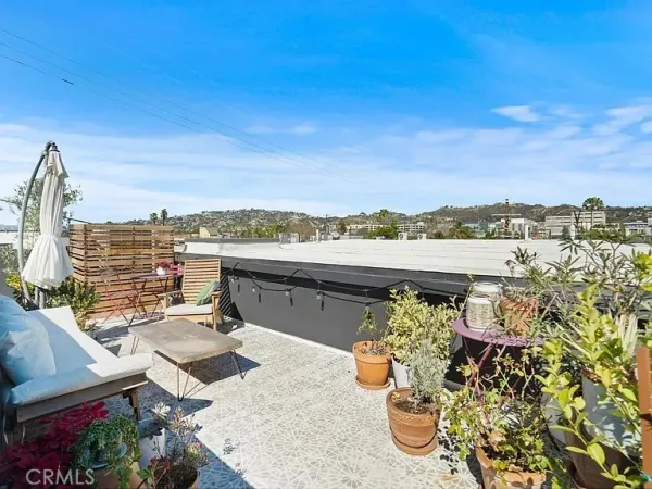 a view of a terrace with wooden floor and city view