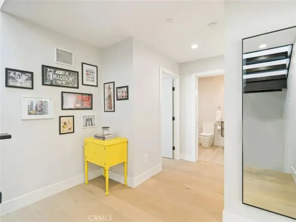 a view of a hallway with bathroom