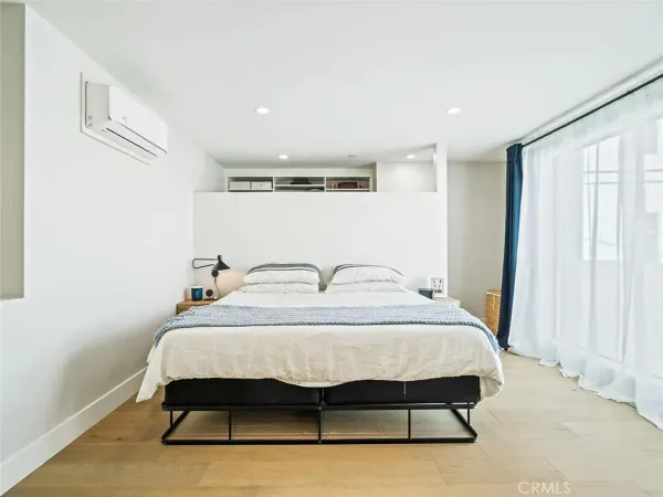 a bedroom with a bed and window
