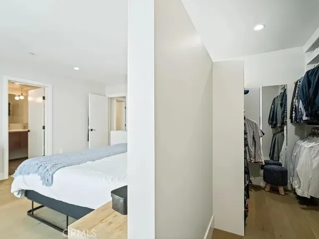 a bedroom with a bed and a view in closet