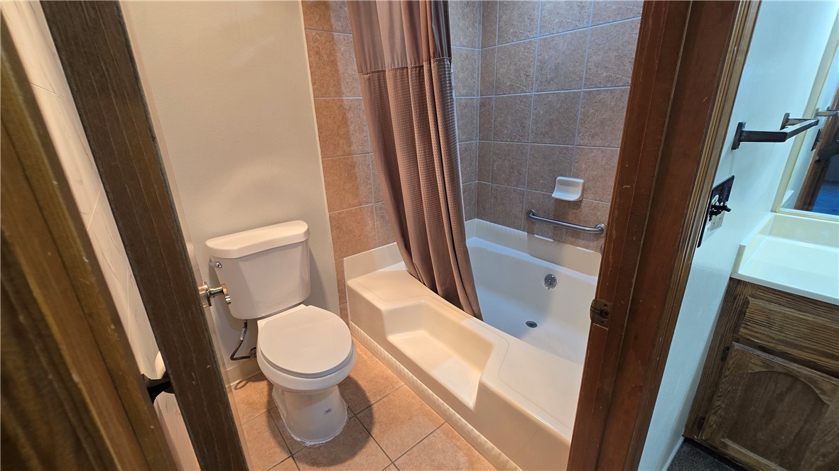 1190 Ramar Road, Unit 27 Bullhead City, AZ 86442 - Photo 12 of 15 a white toilet sitting next to a sink and a mirror