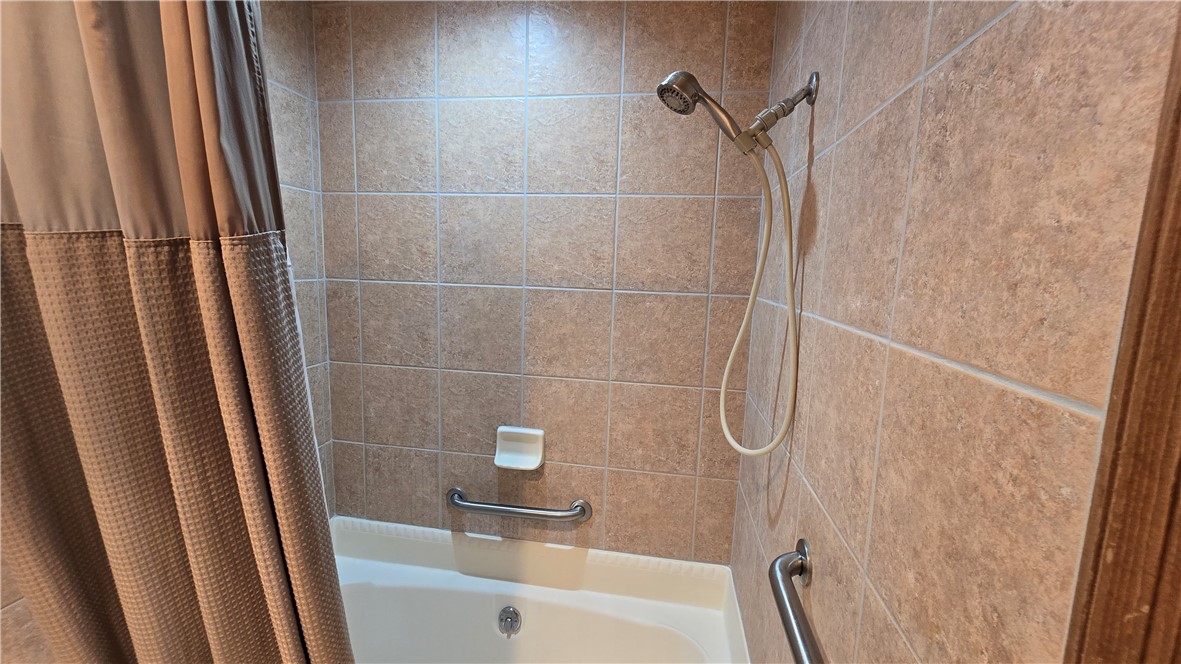 1190 Ramar Road, Unit 27 Bullhead City, AZ 86442 - Photo 13 of 15 a bathroom with a bath tub and a shower