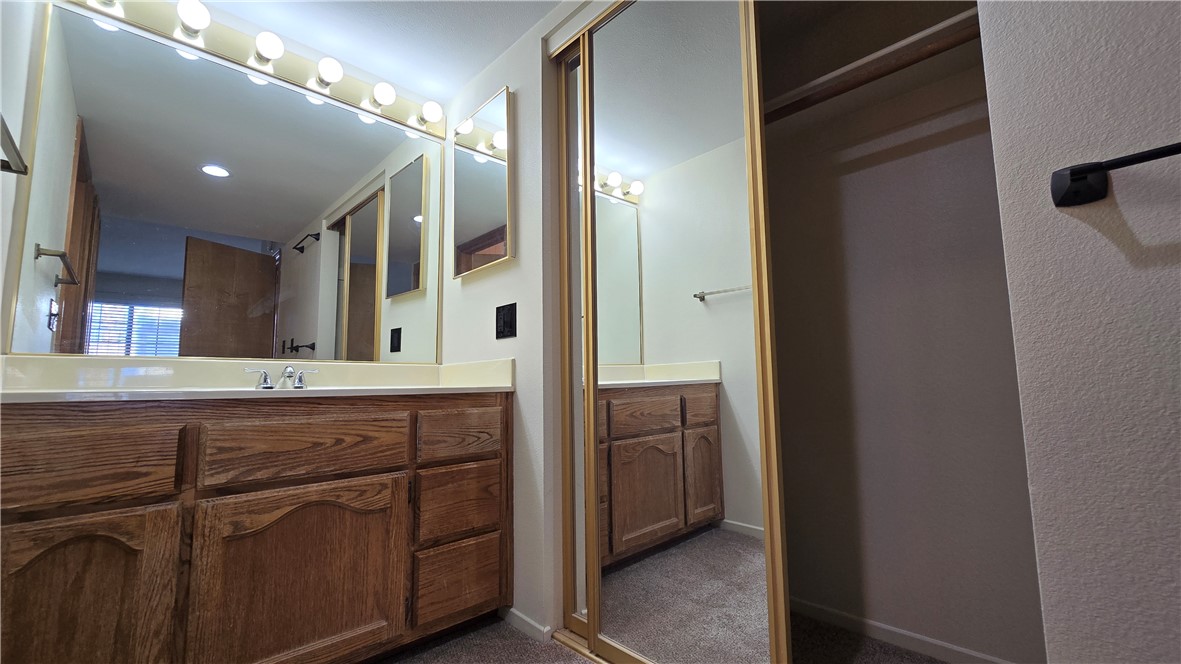 1190 Ramar Road, Unit 27 Bullhead City, AZ 86442 - Photo 14 of 15 a spacious bathroom with a granite countertop sink a mirror and a