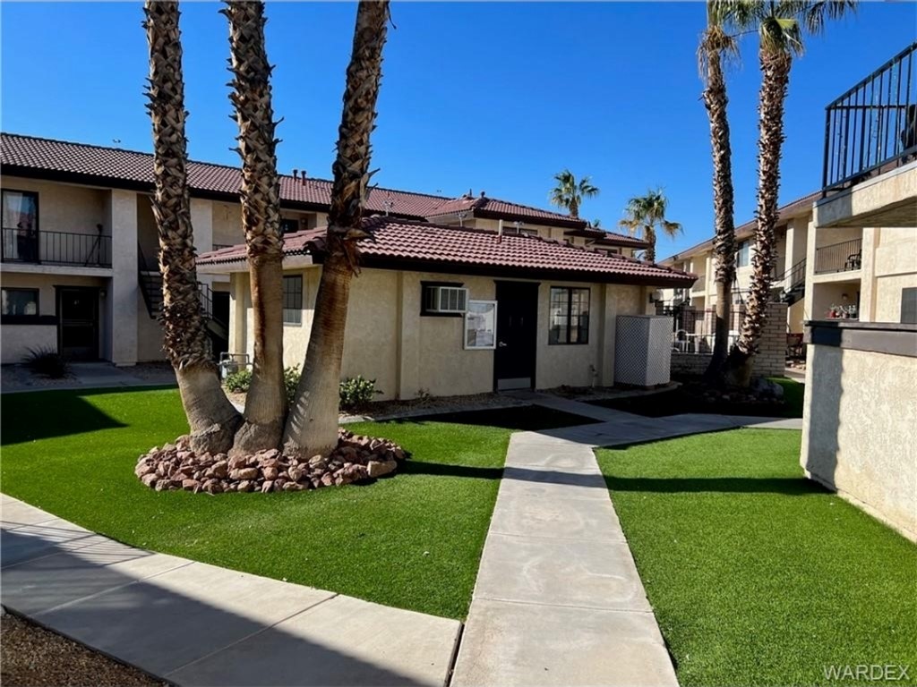 1190 Ramar Road, Unit 27 Bullhead City, AZ 86442 - Photo 6 of 15 a front view of a house with a yard