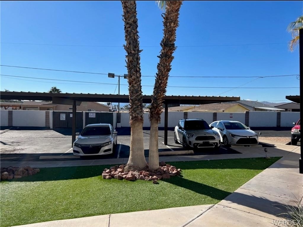 1190 Ramar Road, Unit 27 Bullhead City, AZ 86442 - Photo 7 of 15 a front view of a house with garden
