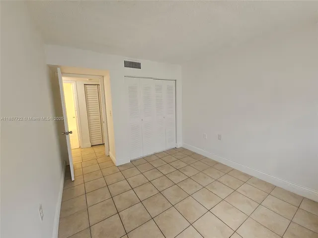 a view of an empty room and wooden floor