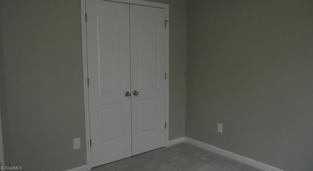 5227 Switchback Drive High Point, NC 27265 - Photo 11 of 15 Bedroom 2 with a great neutral color an double door closet.